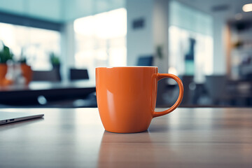 Orange cup of coffee on the table in the office, stock photo