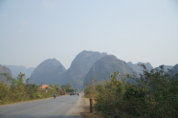 The route of the damaged road is mixed with a dirt road with views of forests and mountains on both...