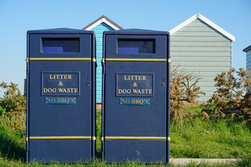 Litter and dog waste bins for public use at beach in the UK. trash and waste disposal 