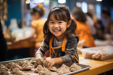 Asian little girl playing with clay