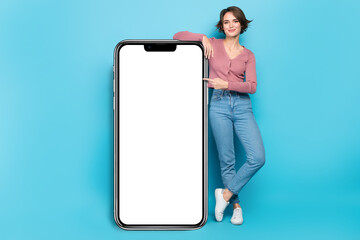 Photo with lady stand near big smartphone direct finger screen display advert promo app board isolated blue color background