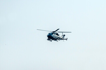 Helicopter flying on isolated blur sky