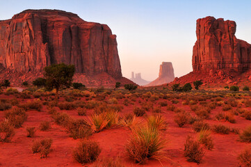 Twilight view of the North Window, between Elephant Butte and Cly Butte, towards East Mitten Butte and other spires and towers of Monument Valley Navajo Tribal Park, Arizona, Southwest USA.