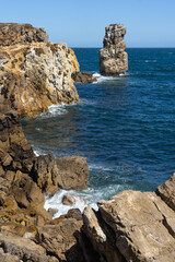 Rock formations of the Papoa island in the site of geological interest of the cliffs of the Peniche peninsula, portugal, in a sunny day.