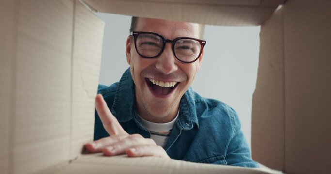 Man, excited for delivery and open box, package or parcel with courier or moving into new house. Cardboard, perspective of gift or present with happy face, unboxing with cargo or stock for relocation