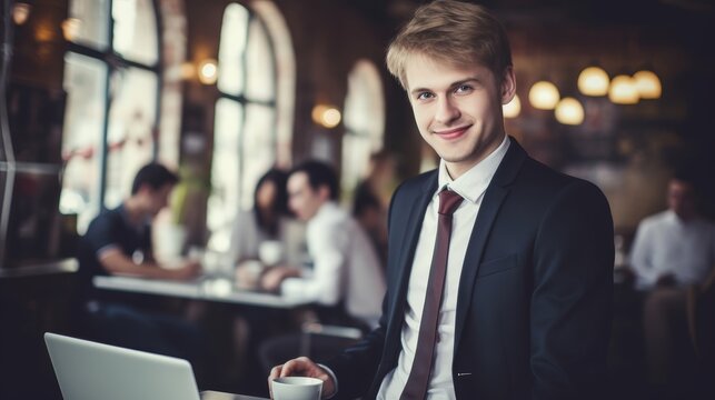 Happy smiling young businessman working online on laptop in cafe, with copy space, banner