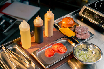 Obraz na płótnie Canvas In the restaurant's kitchen there are all the ingredients to assemble burger