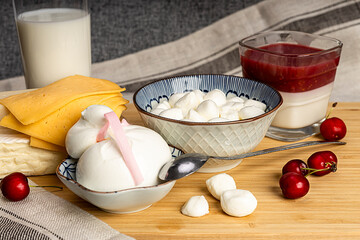 Celebrating the Jewish holiday Shavuot. Kosher fresh dairy products, milk and cheese, wooden background. Dairy products on a wooden background.