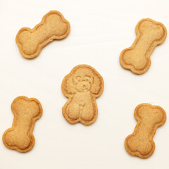 Cookies in the form of a poodle and a bone on the table