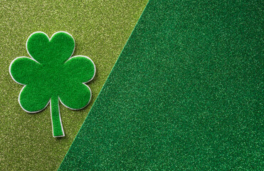 Happy St Patrick's Day decoration concept made from shamrocks ( clover leaf) on green background.