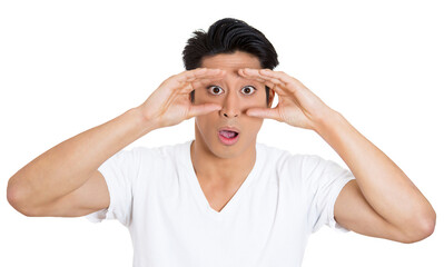 Closeup portrait of young, curious funny man, student, employee looking through his fingers like binoculars, surprised, shocked by what he found in future, isolated on white background - 736107417