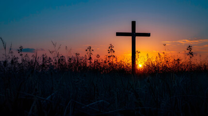 Cross Silhouetted in Field at Sunset