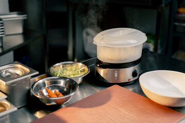 general plan of the table on which there is a steamer with buns everything is ready for cooking