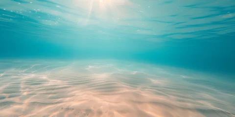 Fotobehang Seabed sand with blue tropical ocean above, empty underwater background with the summer sun shining brightly, creating ripples in the calm sea water © mozZz