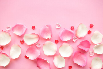 White and pink rose petals on pink background. Copy space for the text