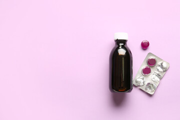 Pills for sore throat with cough syrup on lilac background