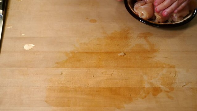 Kitchen 0031 Raw Chicken Onto Plate Cutting Board 