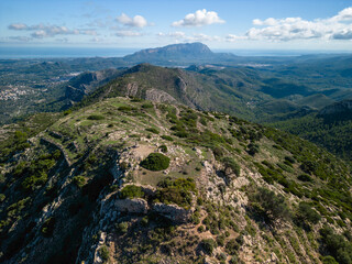 Aerial view of Castell d'Aixa and Castell de la Solana mountain ridge in a sunny blue sky, Lliber, Costa Blanca, Alicante, Spain - stock Photo