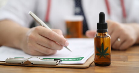 Closeup doctors hand writing prescription for hemp. Doctors prescribe cannabis for sleep...