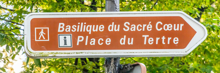 Sacred Heart basilica and Place du Tertre square sign in a street of Montmartre hill in Paris, France - obrazy, fototapety, plakaty