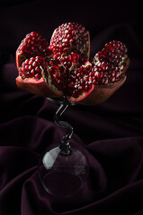 Cut red pomegranate on a glass