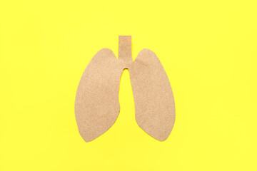 Paper lungs on yellow background