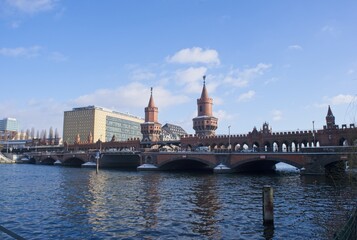 Berlin, Germany - Jan 19, 2024: The Oberbaum Bridge (Oberbaumbrucke) is a double-deck bridge crossing the Spree river in Berlin. Sunny winter day. Selective focus