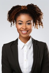 A woman dressed in a business suit smiling at the camera. Suitable for corporate and professional themes
