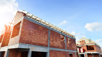 Single-family house under construction in an development estate of small single-family houses.