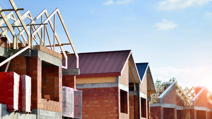 Fototapeta na wymiar Single-family house under construction in an development estate of small single-family houses.