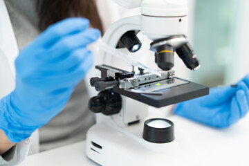 researcher using microscope analyse cell in medical lab.
