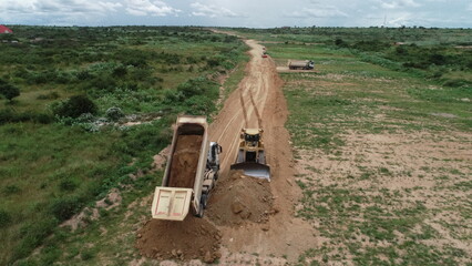 construction machines at works, dozer, roller machine, excavator, crawler rock drill machine, trucks, GPS grader