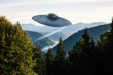 Alien spaceship flying over trees in mountains. UFO © New Africa