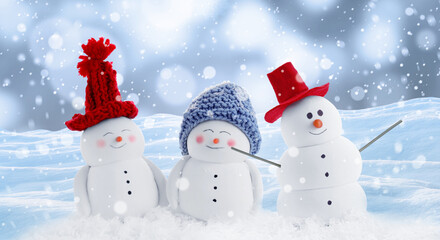 Cute decorative snowmen in hats outdoors on snowy day, banner design