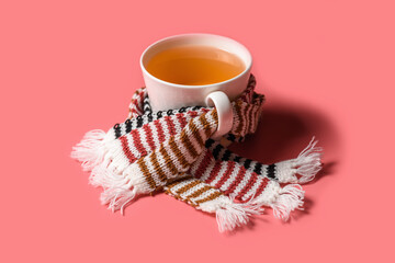 Mug of tea with warm scarves. Spring bad weather.