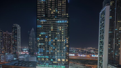 Fototapeta na wymiar Aerial view of Dubai Downtown skyline with many towers night timelapse.