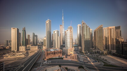 Naklejka na ściany i meble Aerial view of Dubai Downtown skyline with many towers all day timelapse.