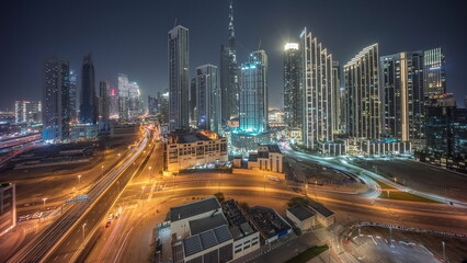 Aerial view of Dubai Downtown skyline with many towers day to night timelapse.