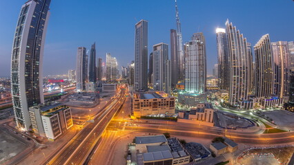 Aerial view of Dubai Downtown skyline with many towers day to night timelapse.