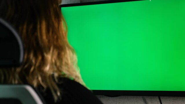 Female doctor works in her office, examines green screen
