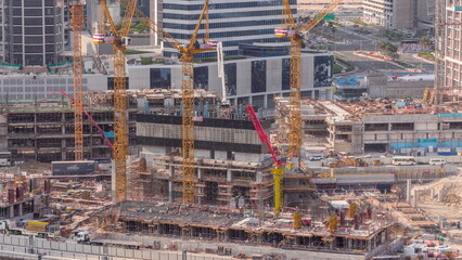 Large construction site with many working cranes timelapse.