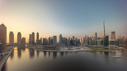 Fototapeta premium Cityscape with skyscrapers of Dubai Business Bay and water canal aerial timelapse.