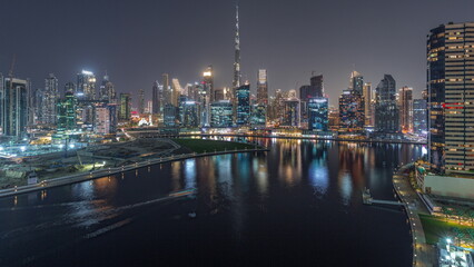 Fototapeta na wymiar Aerial view to Dubai Business Bay and Downtown with the various skyscrapers and towers day to night timelapse