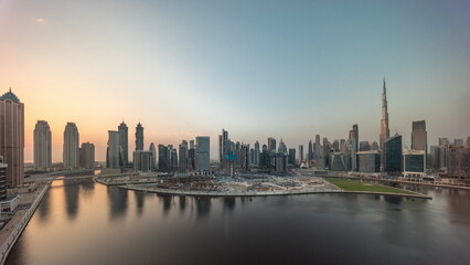 Fototapeta premium Cityscape with skyscrapers of Dubai Business Bay and water canal aerial timelapse.