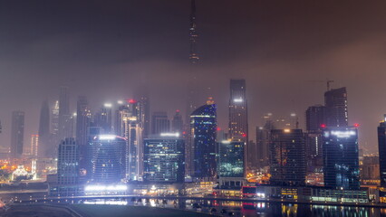 Aerial view to Dubai Business Bay and Downtown with the various skyscrapers and towers all night timelapse