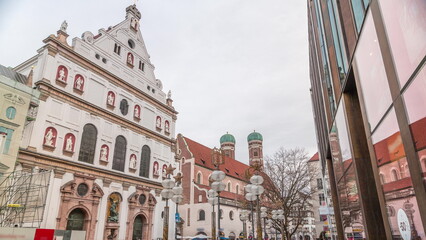 View of the St. Michael's Church and the pedestrian street of Neuhauser in centre of Munich timelapse. Germany. - obrazy, fototapety, plakaty