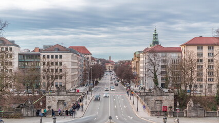 Luitpoldbrucke or Luitpold bridge crossing Kleine Isar river timelapse. Munich city in Bavaria,...