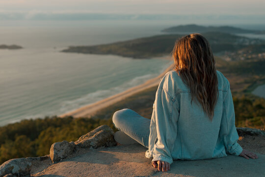 Young girl sitting on the Monteventoso viewpoint in Doni&ntilde;os, Ferrol.