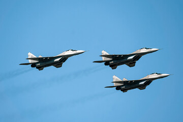 Military air force fighter jet interceptor airplane in full flight against the blue sky