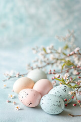 Eastern delight pastel painted eggs with flowers on light blue table background